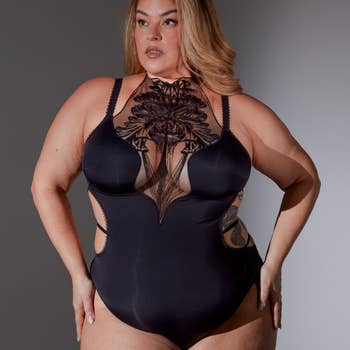 model in a black bodysuit with lace detailing