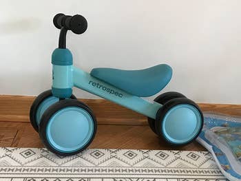 Reviewer's image of light blue and teal colored walker bike