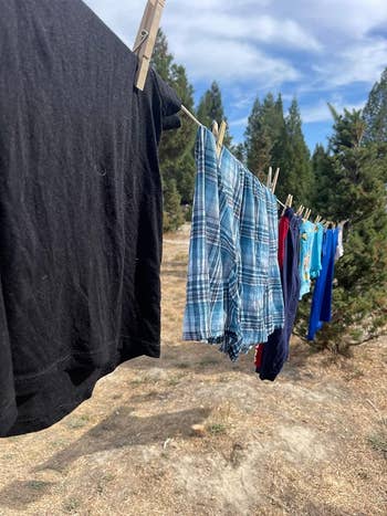 Clothes hanging on a line with wooden pegs outdoors
