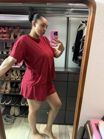 Person taking a reflector  selfie successful  a closet, wearing a relaxed-fit T-shirt and shorts set. Shoes and covering  are disposable   successful  the background