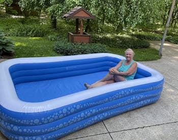 a reviewer sitting in the inflated pool 