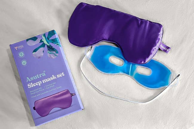 the sleep mask in purple with the cooling insert taken out and sitting next to the packaging 