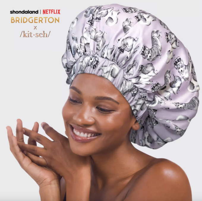 model in large bonnet with gray dog print