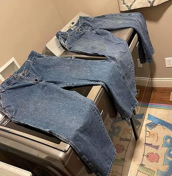 reviewer photo of the same jeans looking much cleaner after being treated with the stain remover