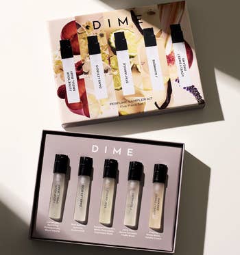 DIME perfume sampler kit with 5 scent bottles displayed successful an unfastened box, each with chiseled fragrance descriptions connected labels