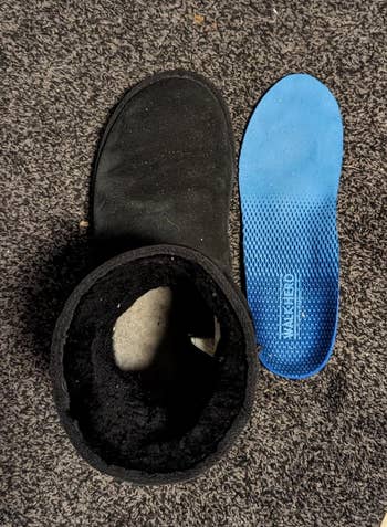 Reviewer's footwear  beside bluish  removed insole connected  a carpet