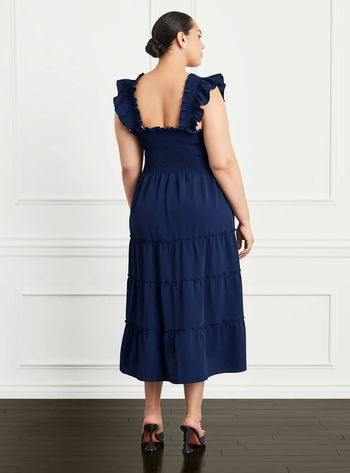 back of model wearing the navy dress with black heels