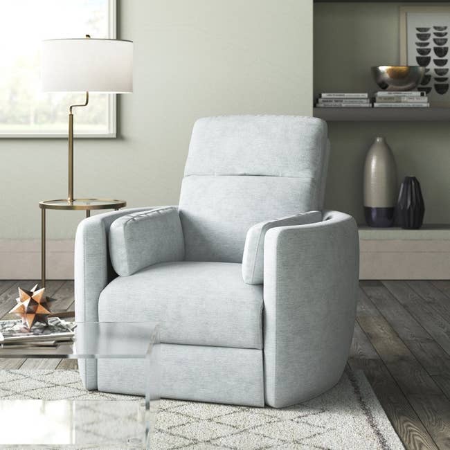 the light blue polyester recliner in upright seated position