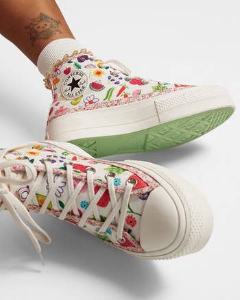 the converse on a model in the colorful fruits and florals pattern
