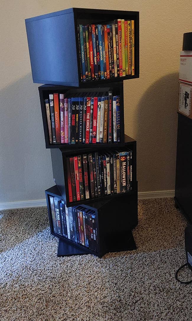 Reviewer's four tier shelf with DVDs shelved on it