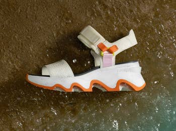 Sandal with chunky sole and velcro straps washed up on the shore