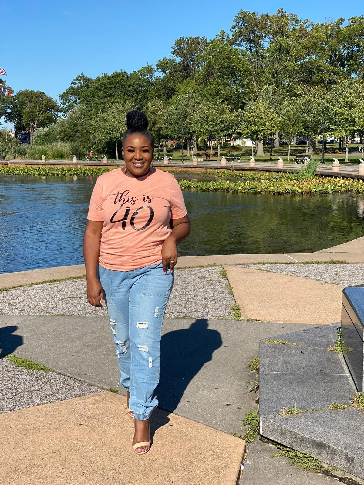 reviewer walking toward the camera in the distressed jean joggers
