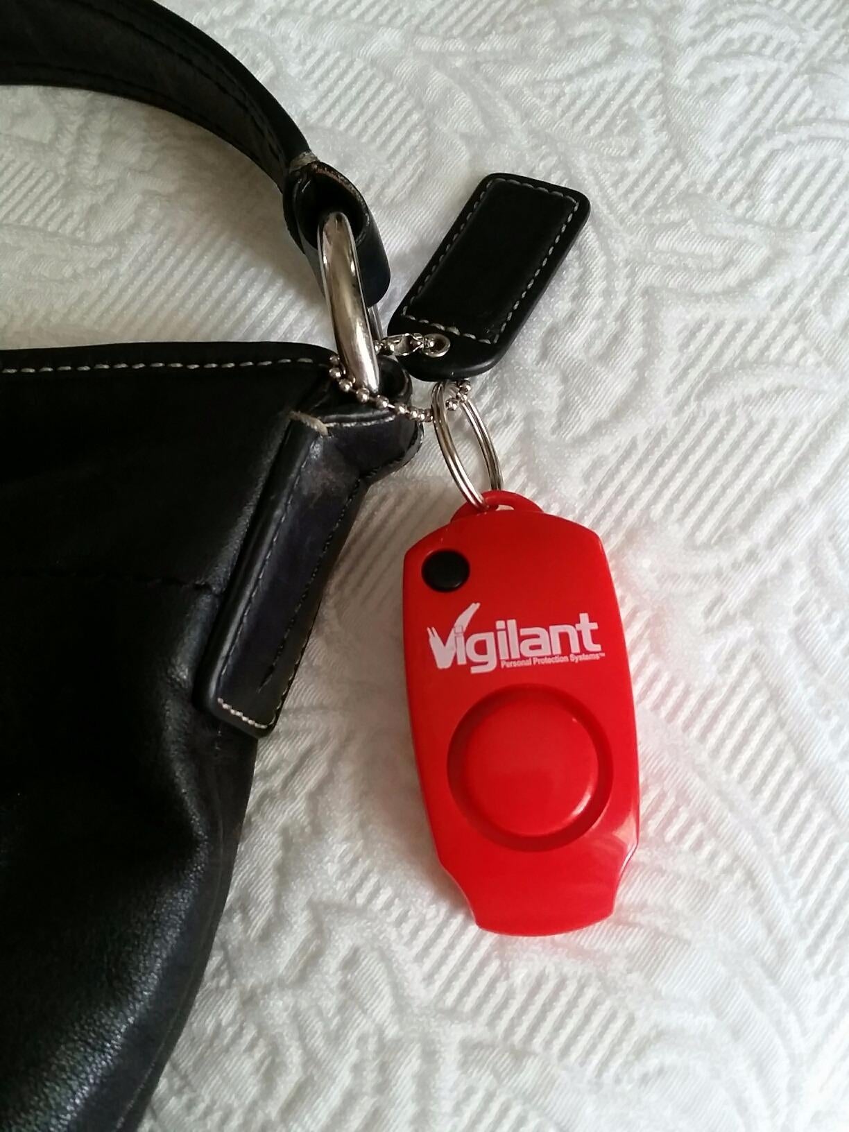 the red personal alarm attached to a bag