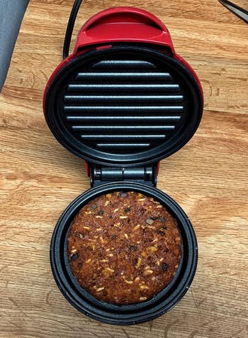 Reviewer image of red panini press grilling burger