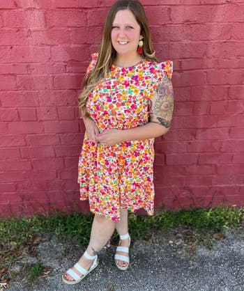 reviewer in a floral version of the dress 