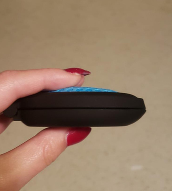 same reviewer holding the folded down brush and mirror