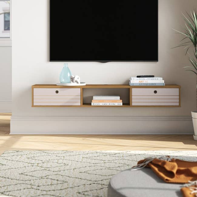 The TV stand in the color Cinnamon/Off-White