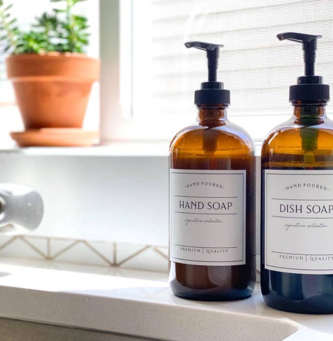 the two amber bottles labeled as hand soap and dish soap, respectively