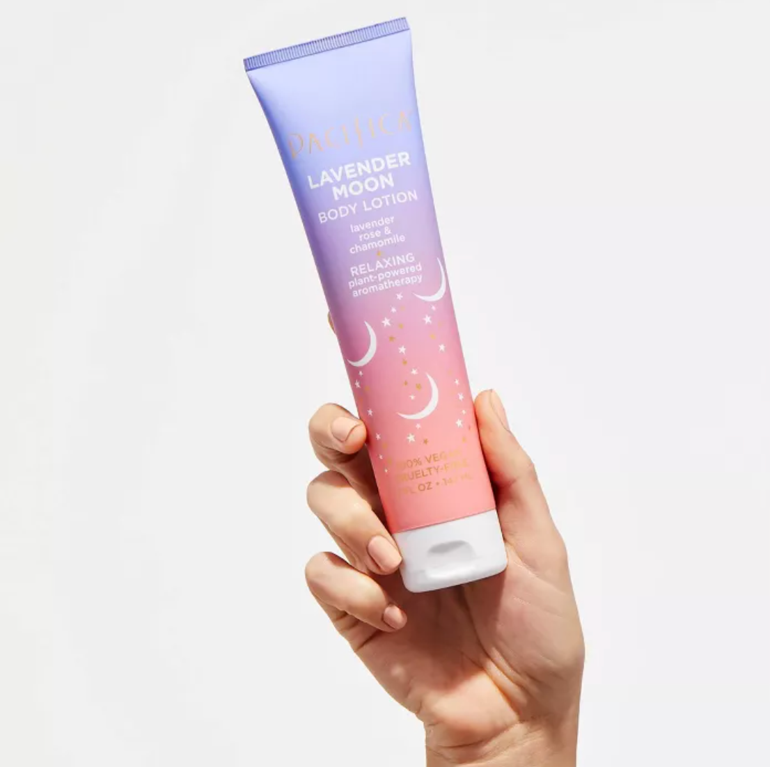 A model holding the bottle of lotion