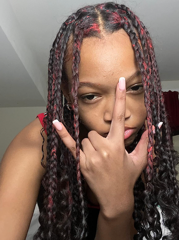 Reviewer with red streaks in dark braided hair