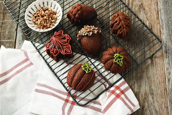 bite-sized desserts connected  cooling rack each   shaped similar  an acorn, squash, oregon  leaf