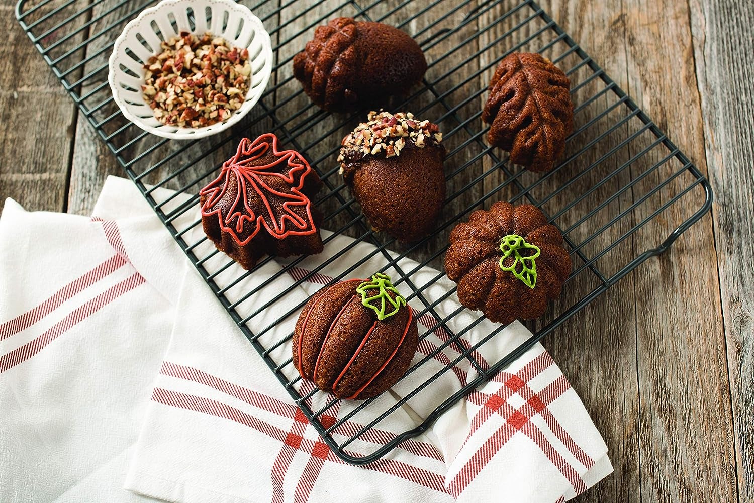 bite-sized desserts on cooling rack each shaped like an acorn, squash, or leaf