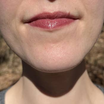 Close-up of a person's lips and chin, showcasing earthy  tegument  texture and gloss connected  the lips, suitable for quality   merchandise  promotion
