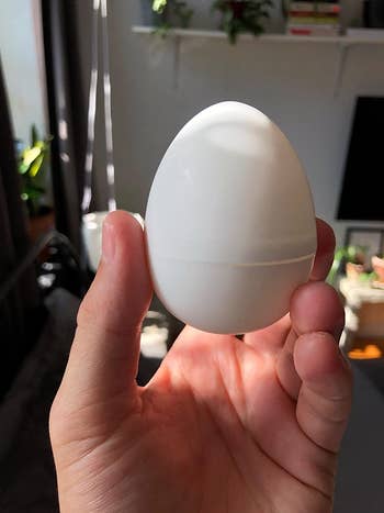 Reviewer holding egg-shaped sleeve