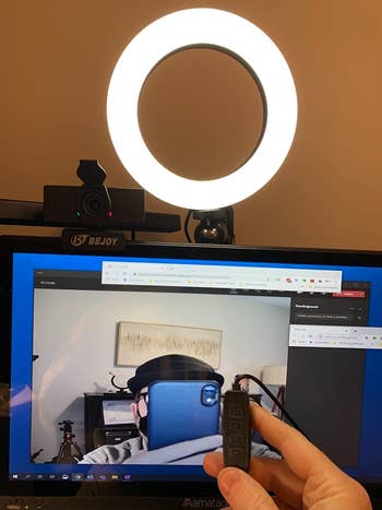 a reviewer testing the ring light with their laptop, showing how bright their picture is in a video