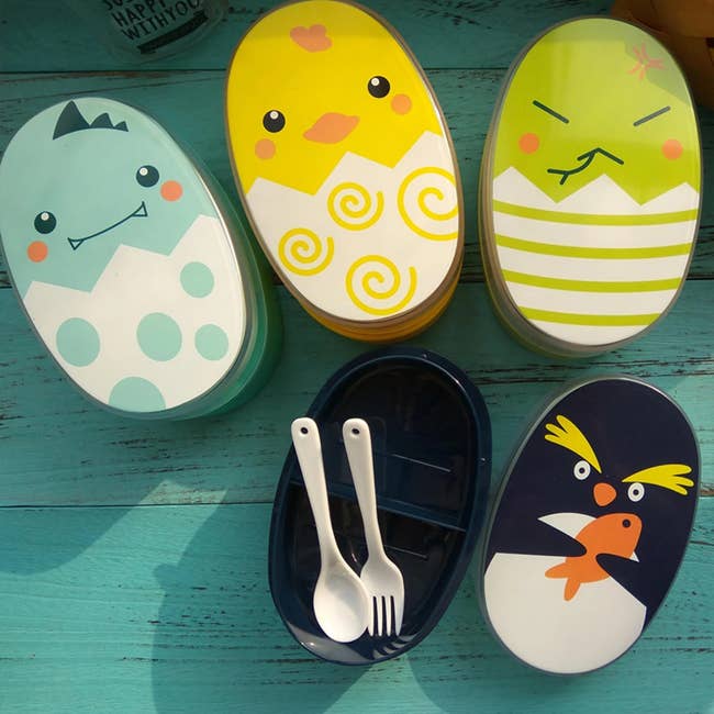 four kids bento boxes illustrating different animals and characters 