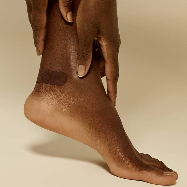 model's foot with bandage on their heel
