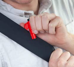 model using red tool to cut a seatbelt