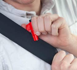 model using red tool to cut a seatbelt