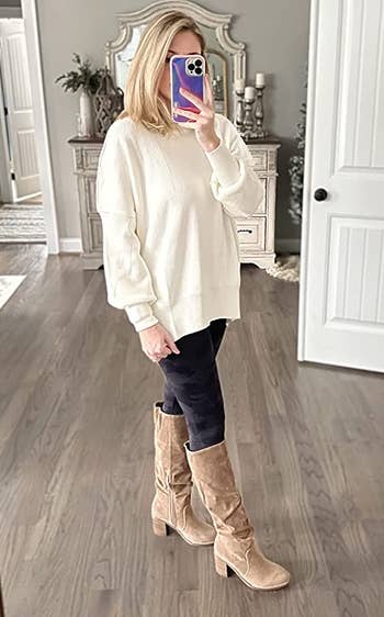 reviewer wearing the sweater in white