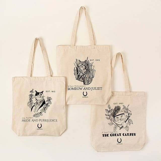 three tote bags with cat illustrations and sayings on them pertaining to classic literature, including Pride And Purrjudice, The Great Catsby, and Romeow and Juliet