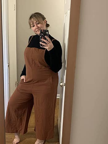 reviewer wearing the brown jumpsuit with a black long-sleeve underneath