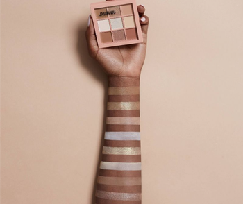 model wearing swatches of neutral shadows from palm size square palette
