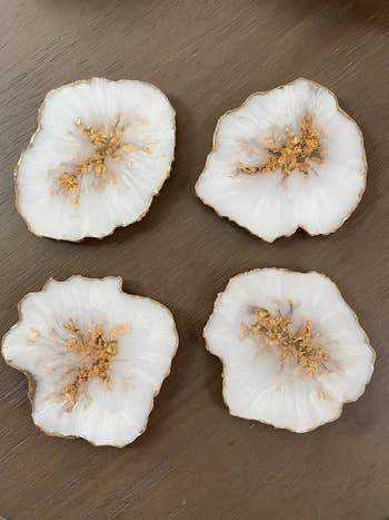 A reviewer's white and gold geode coasters