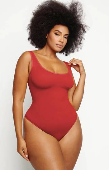 model in the red bodysuit