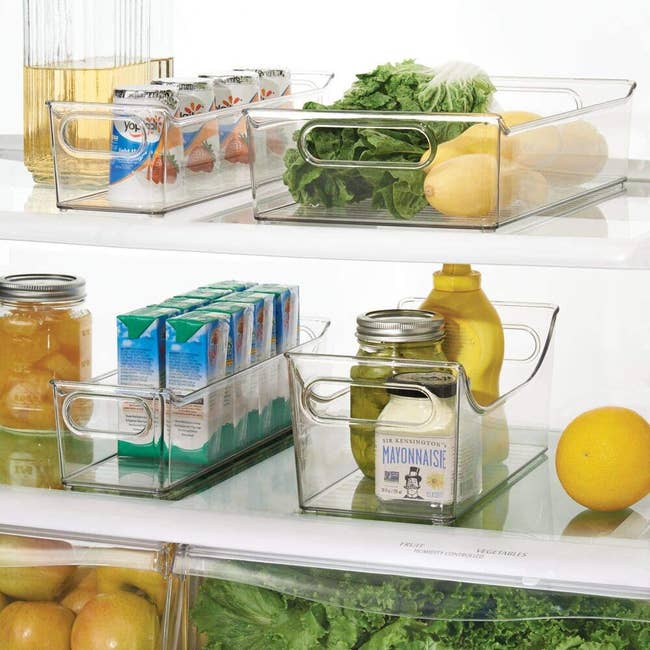 clear bins; two narrow holding yogurts, one wide and low holding produce, one medium and high holding condiment bottles