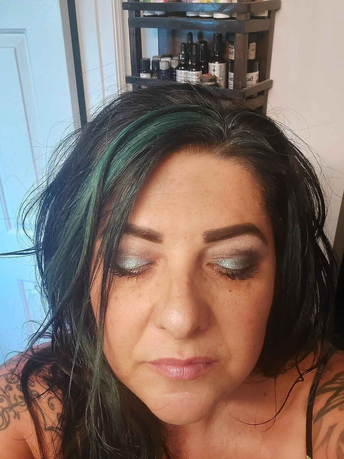 another reviewer wearing the evergreen shimmer eyeshadow on their lids