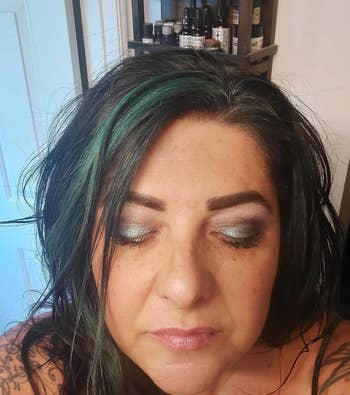 another reviewer wearing the evergreen shimmer eyeshadow on their lids