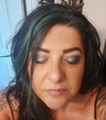 another reviewer wearing the evergreen shimmer eyeshadow on their lids