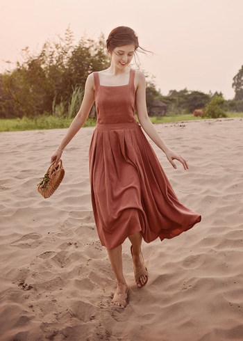model in the sleeveless square neck rust color midi dress