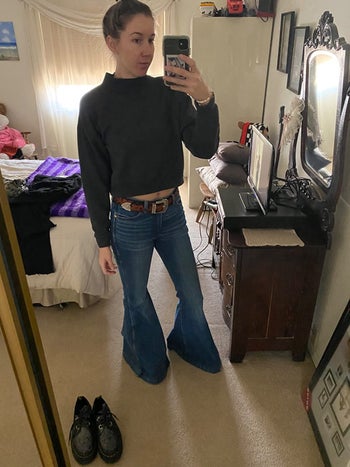 reviewer mirror selfie wearing extra long, flared jeans