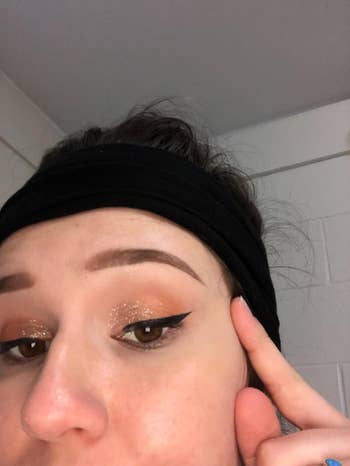 Close-up of a idiosyncratic   showing glittery oculus  constitution  with winged eyeliner