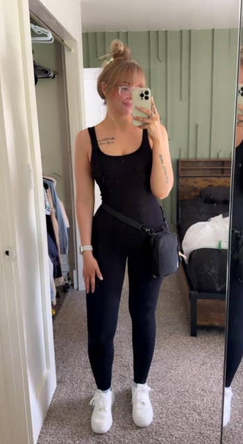 A reviewer successful  a sleeveless achromatic  bodysuit 