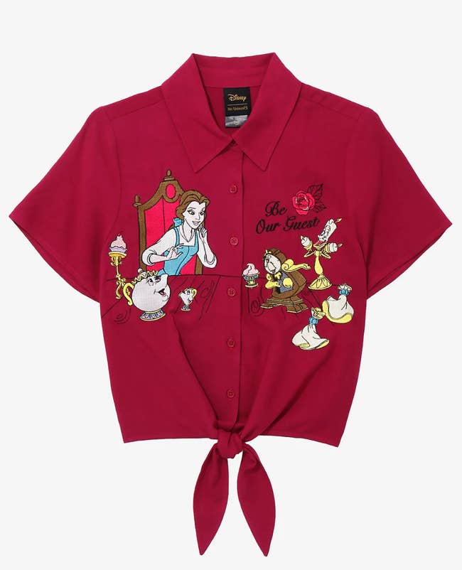 a red tie front short sleeve shirt with belle and an array of other beauty and the beast characters on it