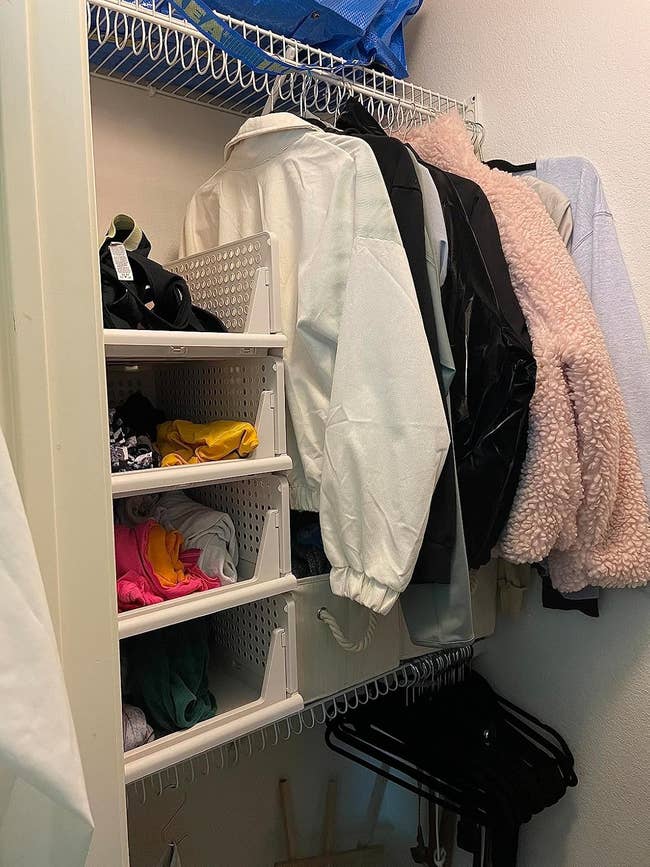 Organized closet with achromatic drawers