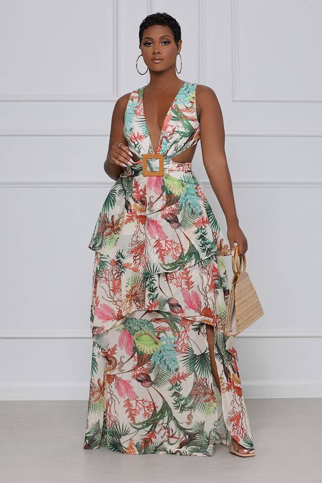 model in the sleeveless white and colorful print dress
